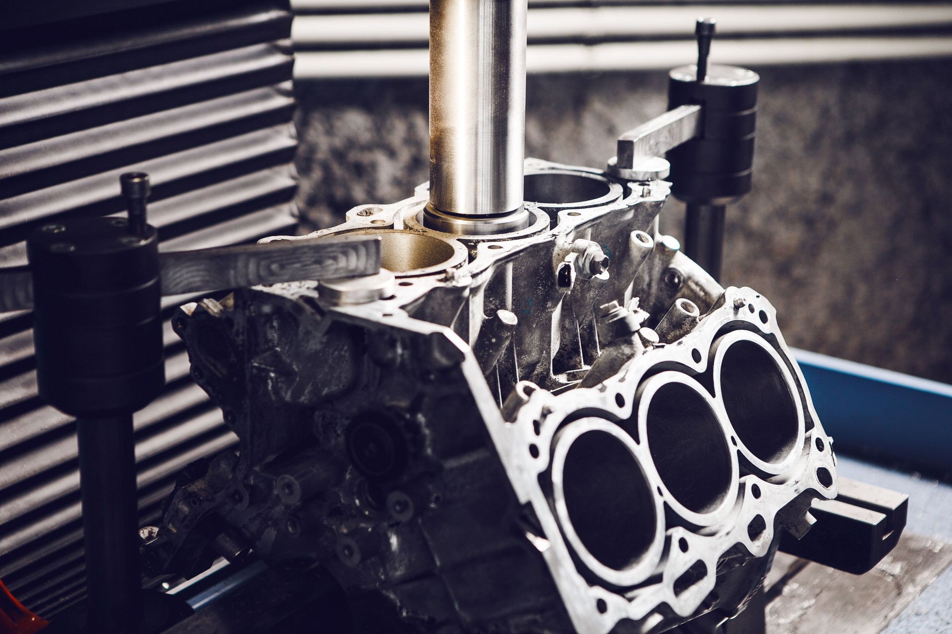 Three-cylinder engine repair on CNC machine, boring under the piston using machine with Computer Numerical Control.